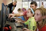 Doug Tarr (background) and young coders at work