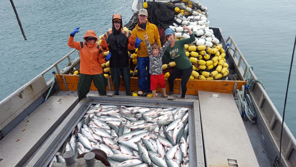 The crew, including Megan’s sons, posing with a completely full hold of fish