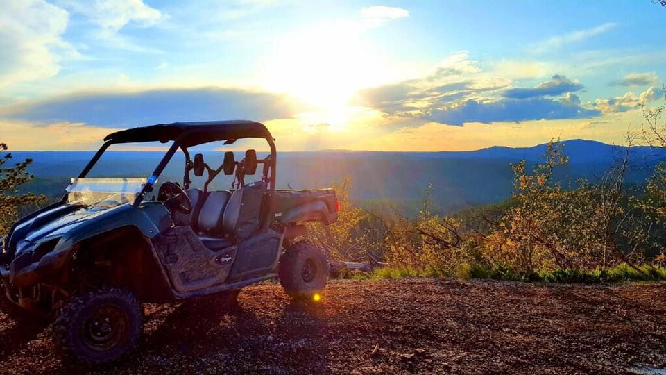 A UTV near the top of Custer Peak, visitors hike the rest of the way up for a grand view