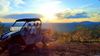 A UTV near the top of Custer Peak, visitors hike the rest of the way up for a grand view