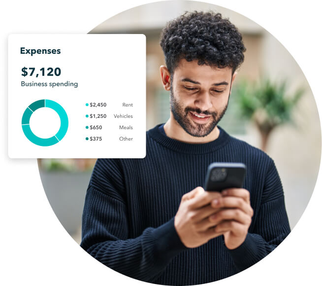 A person holding a cell phone in his right hand.