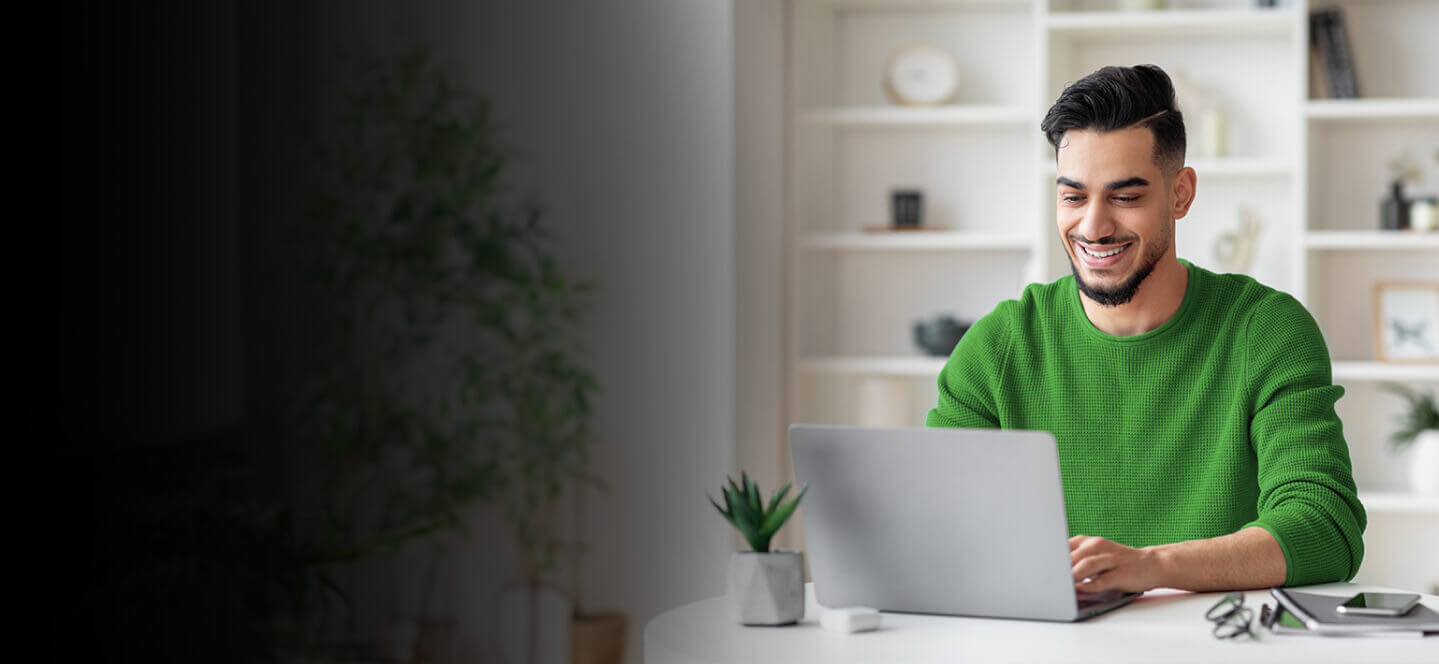 A person sitting at a desk with a laptop.