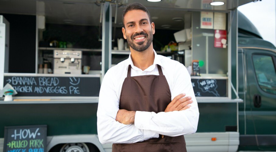 Business owner standing in front of food truck
