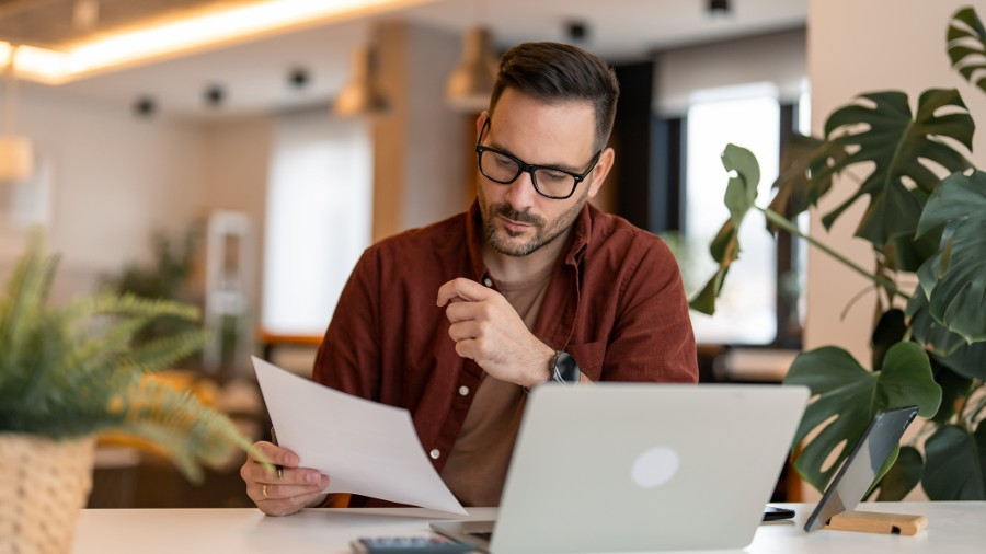 Business owner calculating his taxes at home