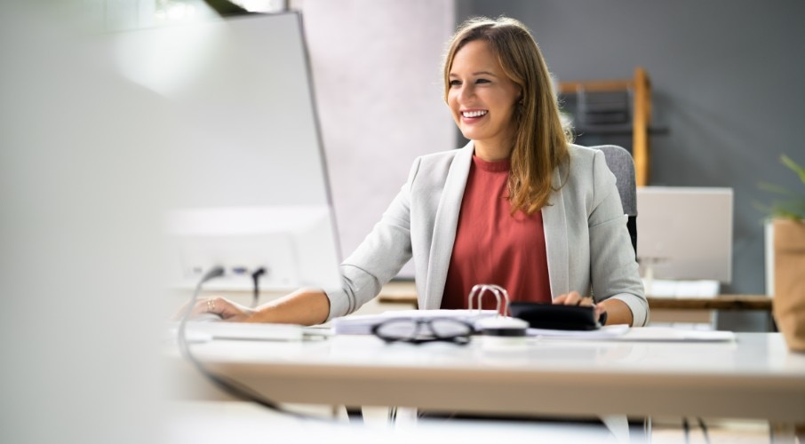Bookkeeper smiling while sitting at a desk