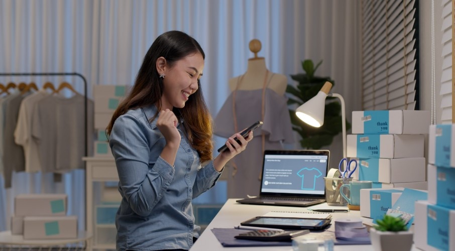 Small business owner looking at budgeting software on phone