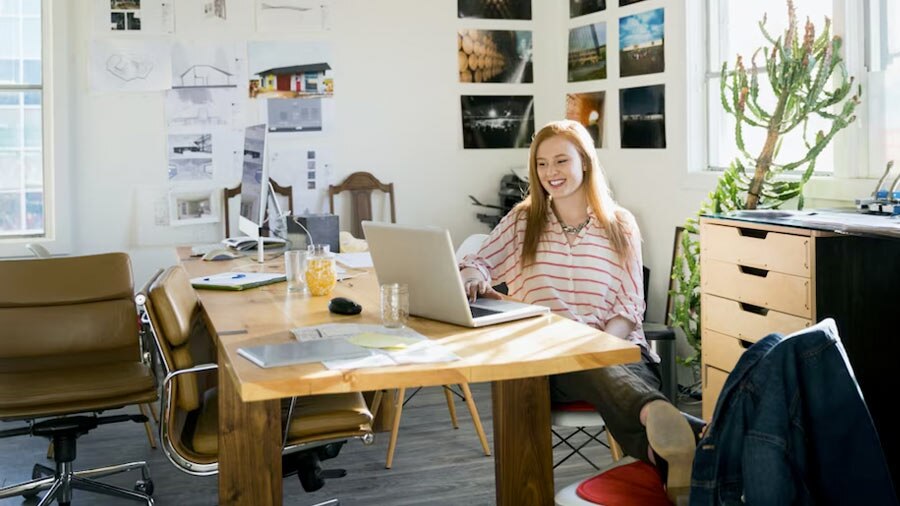 A person sitting at a desk with a laptop computer.