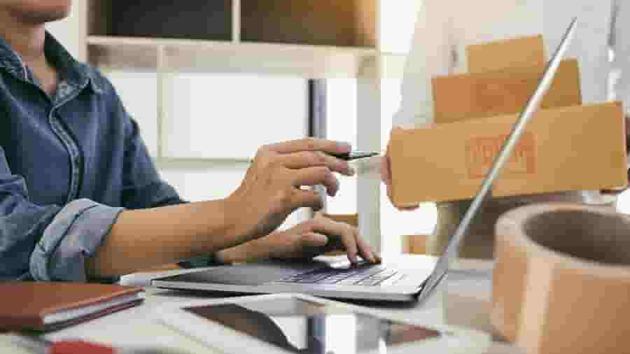 A person checking inventory on a laptop.