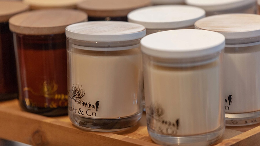 Three jars of vanilla and chocolate are on a shelf.