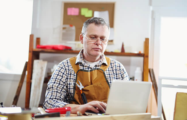 A person sitting at a desk with a laptop.