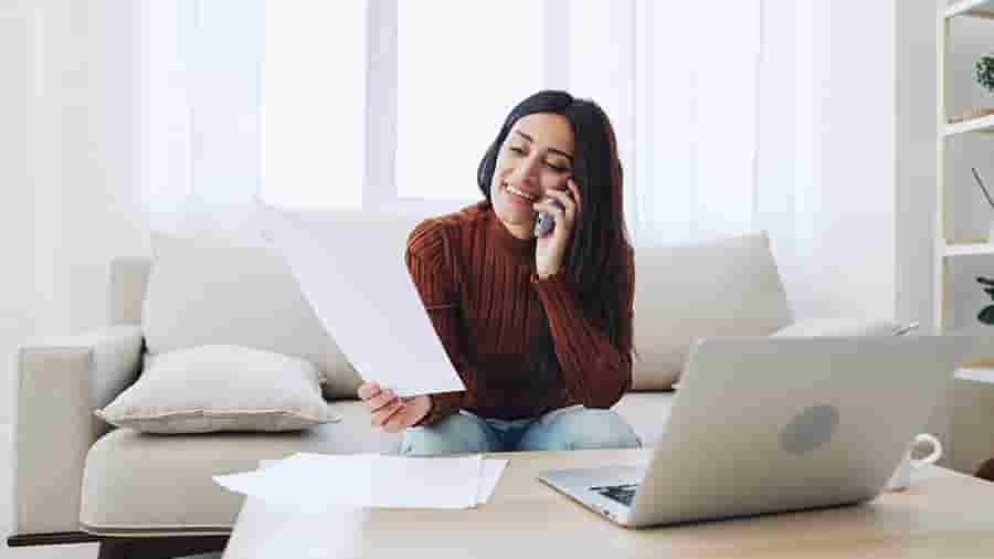 A person sitting on a couch with a laptop.