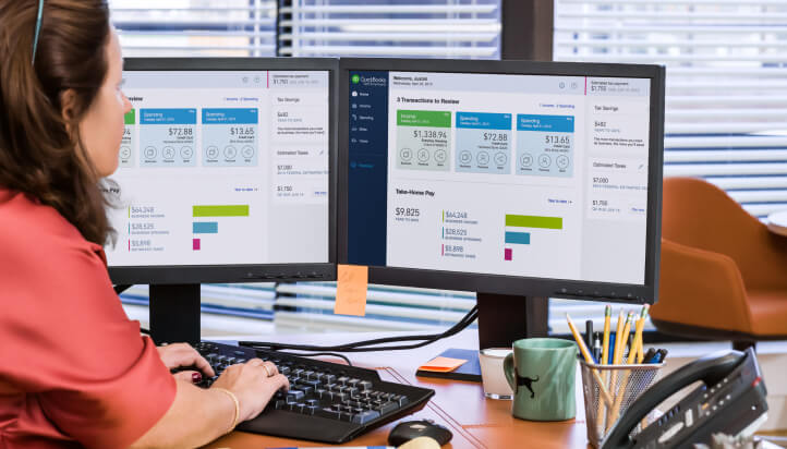 Multi-screens with QuickBooks software on and a keyboard