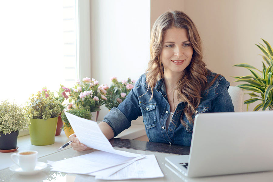 A person sitting at a desk with a laptop.