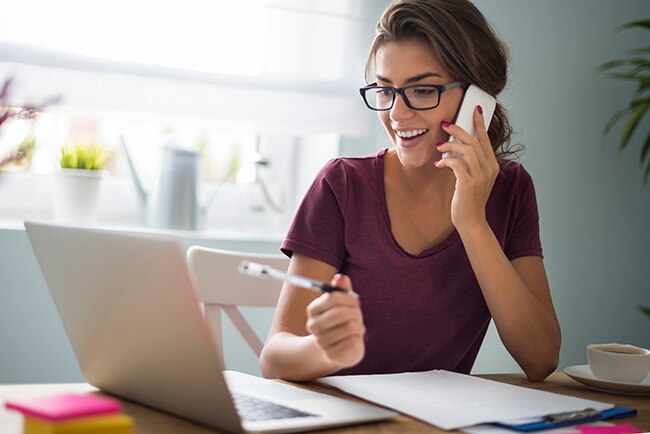 Female blogger working on a laptop at home