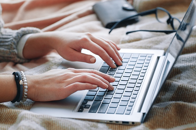 Female hands type on laptop. Job searching online.