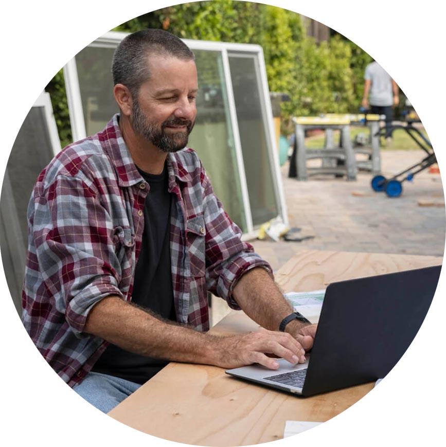 A person sitting at a table with a laptop.