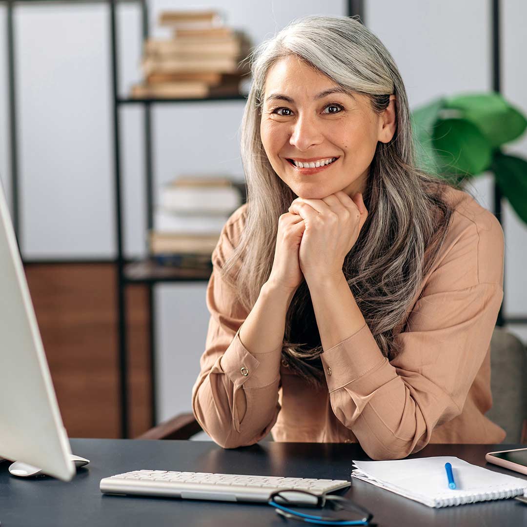 A person sitting at a desk with a laptop.