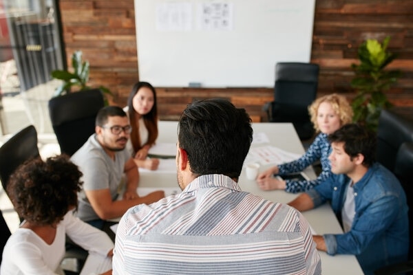 A group of people sitting around a table.