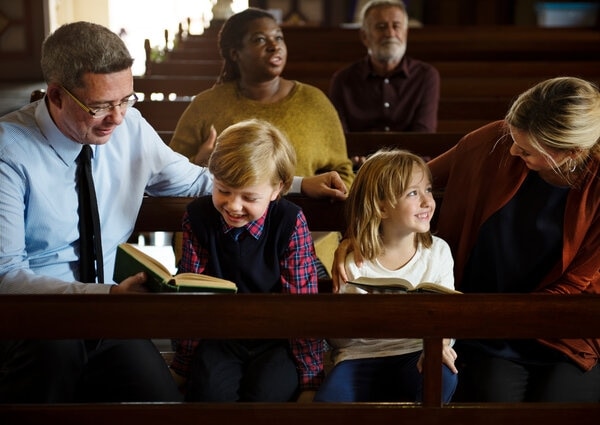 A person reading a book to a group of children.