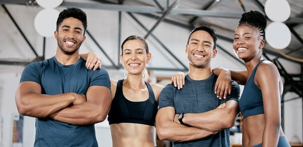 Three people pose for a picture in a bathroom.