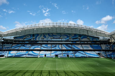 A large stadium with a large blue bench.