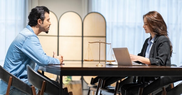 A person sitting at a desk with a laptop computer.