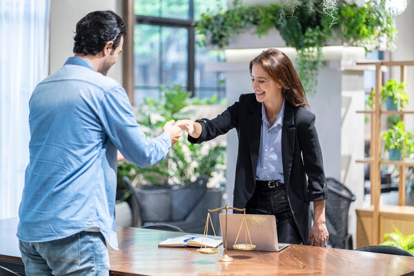 A person standing next to a person in front of a table.