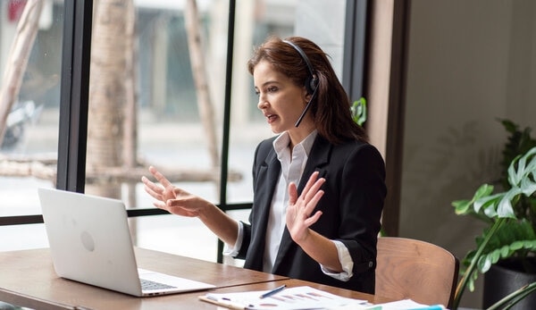 A person in a business suit talks on a cell phone.