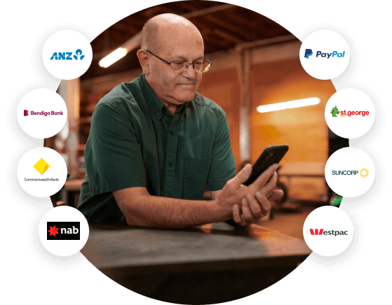 Small business owner smiling while glancing at the QuickBooks App