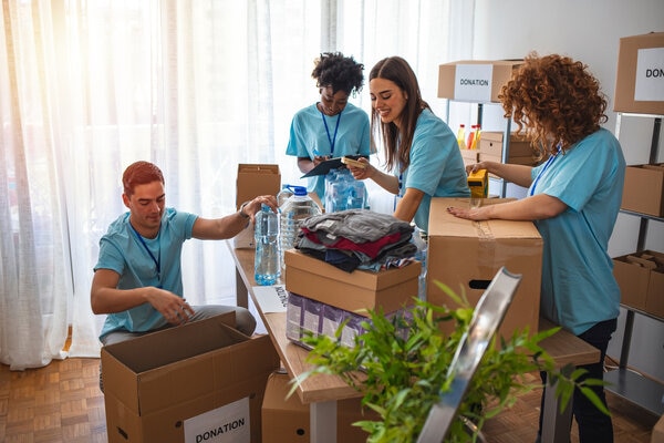 A group of people in a room with boxes.