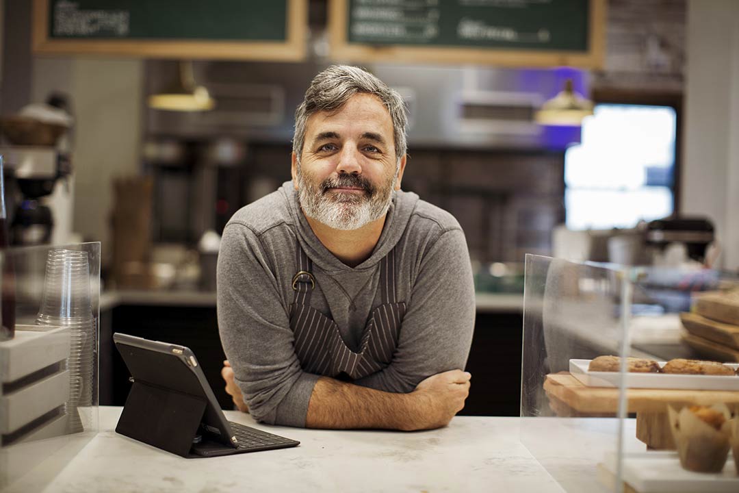 Business owner leaning on counter