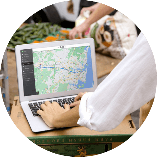 Sole trader calculating miles on map on laptop