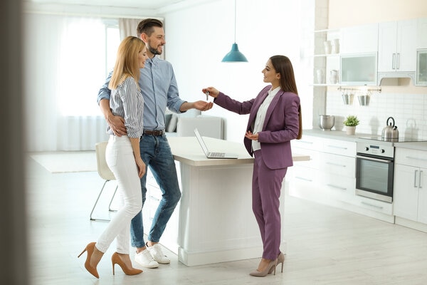 A person standing next to a person on a kitchen counter.