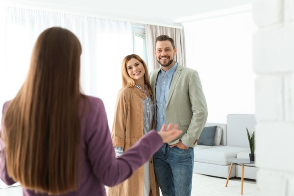 A person standing next to a person in a living room.