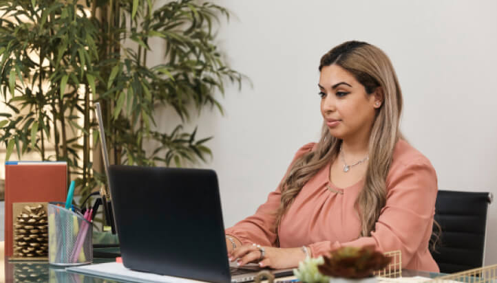 Businesswoman using laptop to learn how to Document management in QuickBooks Online Accountant