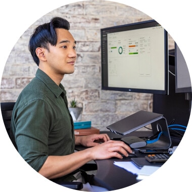  Man working on a computer looking at QuickBooks Online