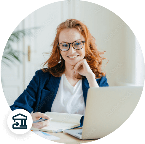 Businesswoman smiling and taking notes in front of a laptop while using QuickBooks to view a Bank Reconciliation report