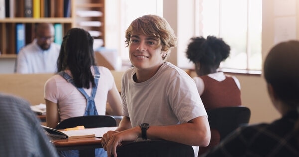 A person sitting at a desk with a laptop computer.