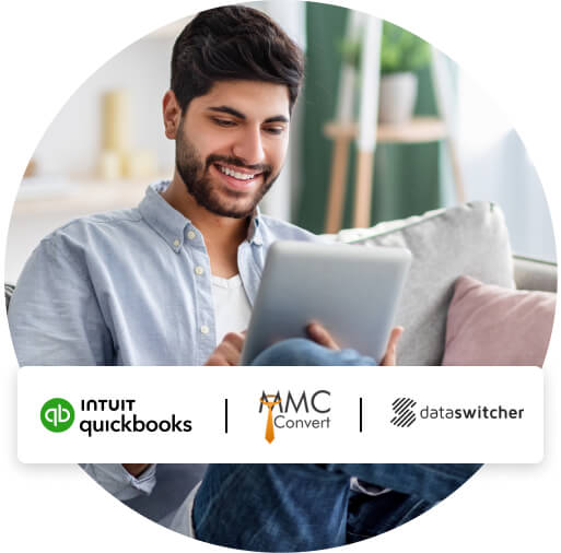 A man seated on a couch using a tablet to switch to QuickBooks with our moving partners, Dataswitcher and MMC Convert