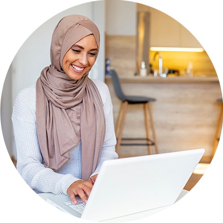 A person sitting at a table with a laptop.