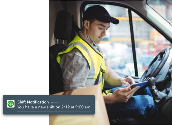 QuickBooks-Time-Man-on-a-van-checking-his-phone-notification-image