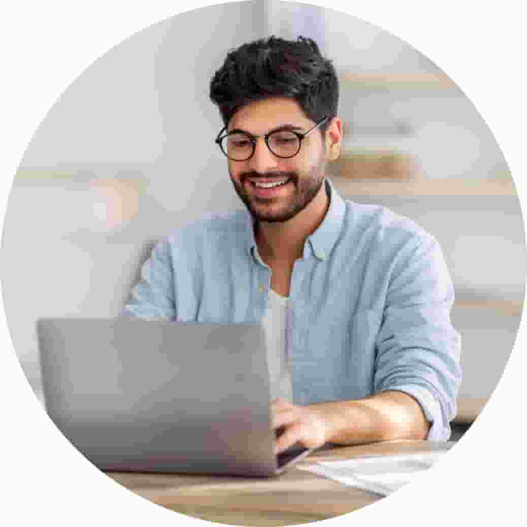 A person sitting at a desk with a laptop computer.