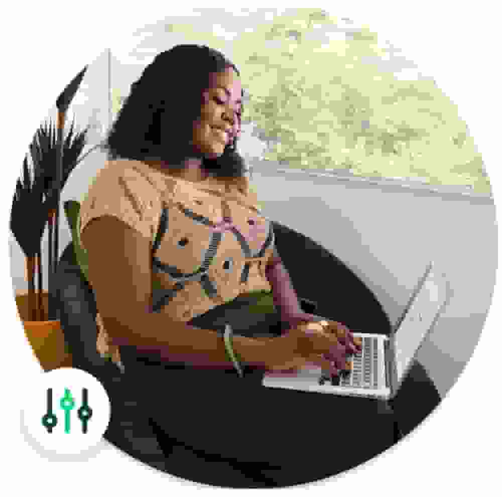 A woman sitting and working on a laptop