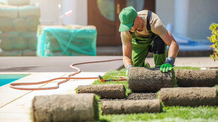 A person is working on a garden planter.