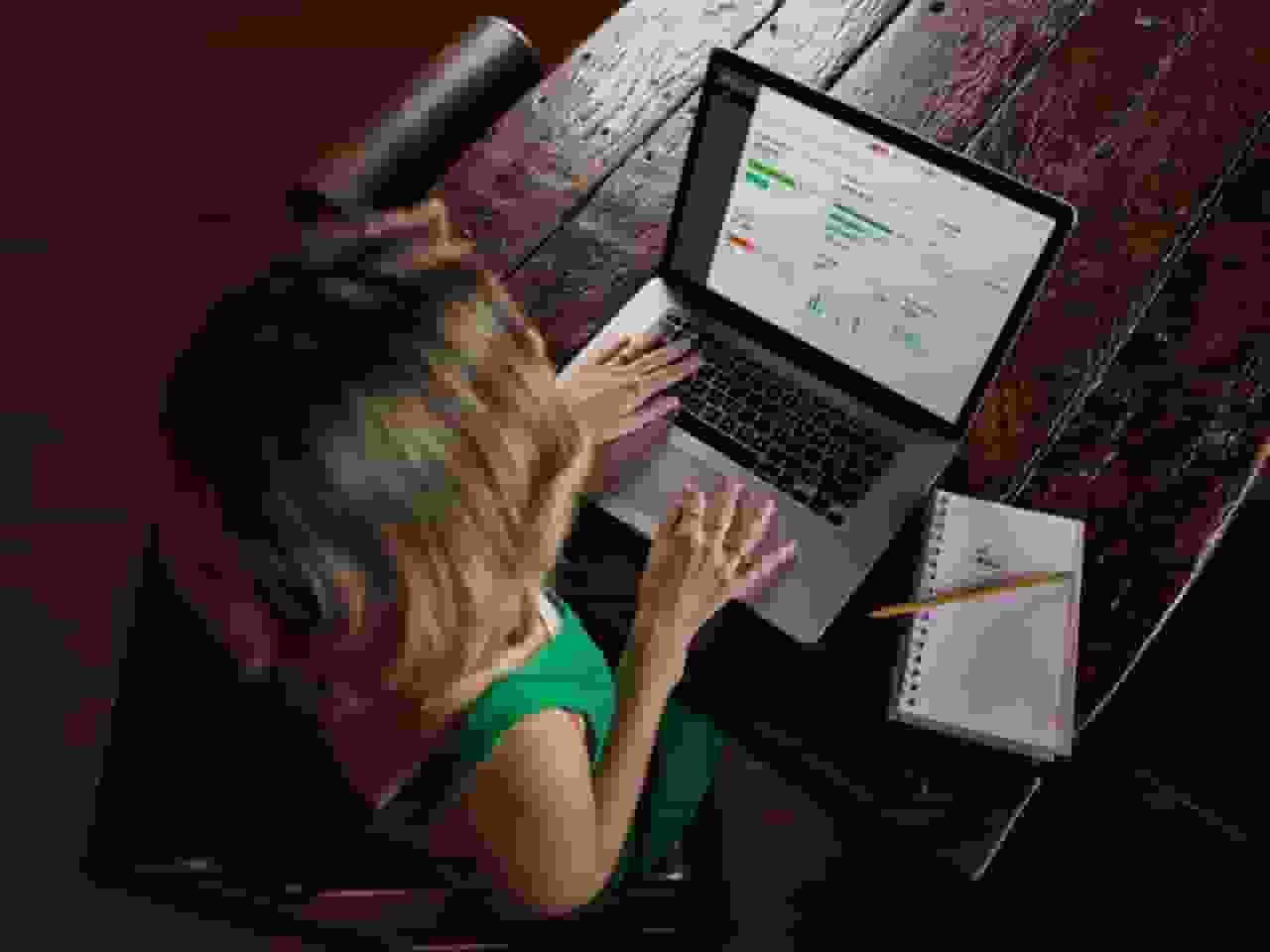 Image of person using a laptop at a desk