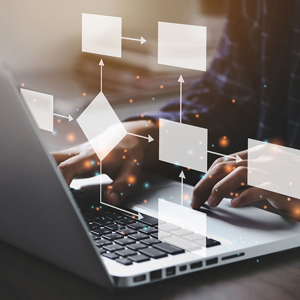 Person using laptop with overlaid flow-chart, representing workflow automation with QuickBooks Online