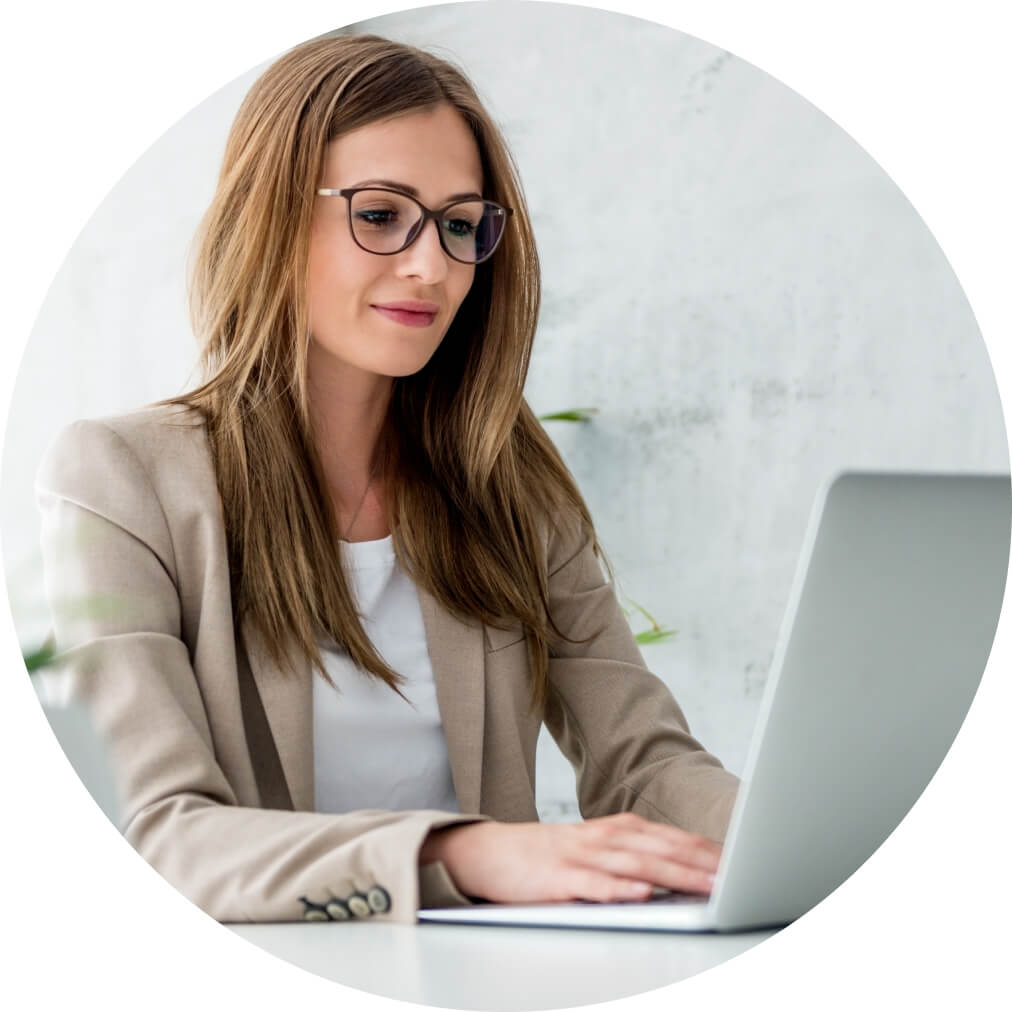 A woman sitting at a table with a laptop.