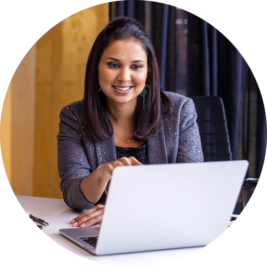 A person sitting at a table with a laptop.