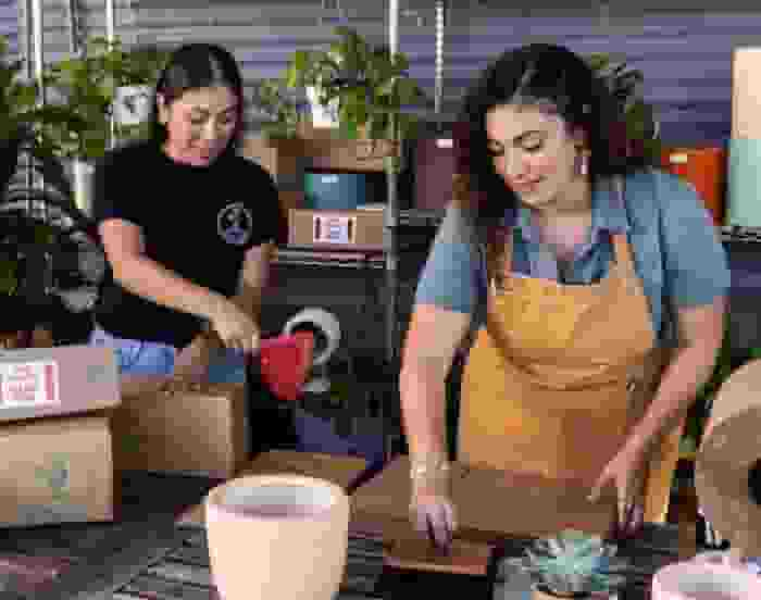 A group of people working on packing products.