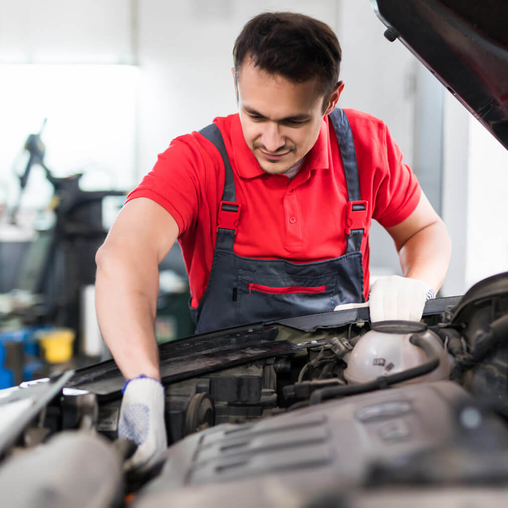 A person working on a car in a garage.